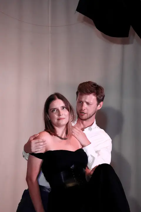 A duet scene in front of a light curtain