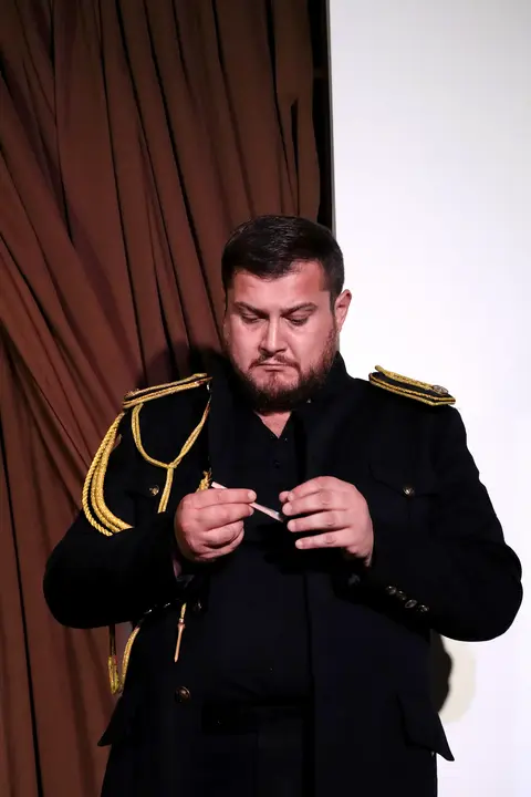 A singer in uniform on stage